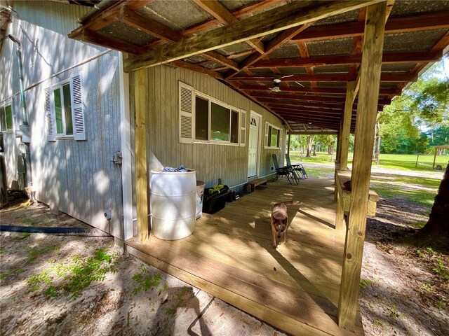 exterior space with a wooden deck and ceiling fan