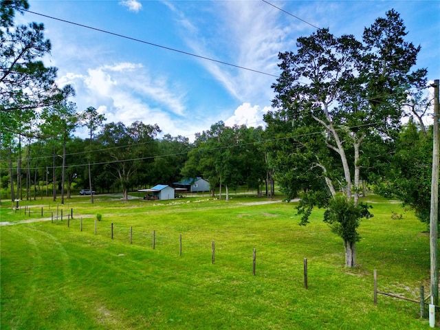 view of yard featuring a rural view and an outdoor structure