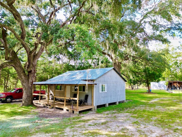 back of house featuring a wooden deck and a lawn