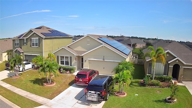 view of front of house featuring solar panels, a front lawn, and a garage