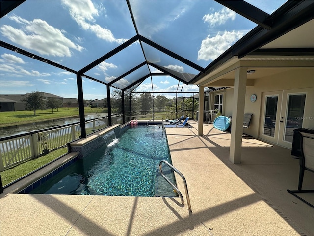 view of pool featuring a patio area, french doors, a lanai, pool water feature, and a water view