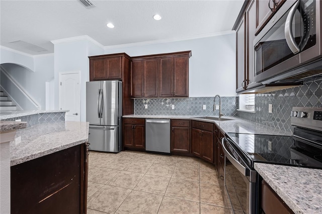 kitchen featuring light stone countertops, sink, backsplash, stainless steel appliances, and crown molding