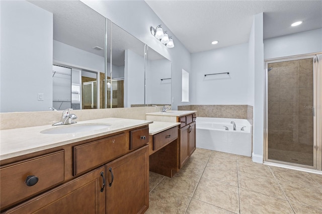 bathroom featuring vanity, a textured ceiling, shower with separate bathtub, and tile patterned flooring