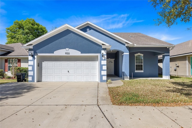 ranch-style home with a front yard and a garage