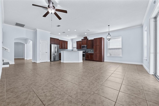 unfurnished living room featuring crown molding, a textured ceiling, light tile patterned flooring, and ceiling fan with notable chandelier