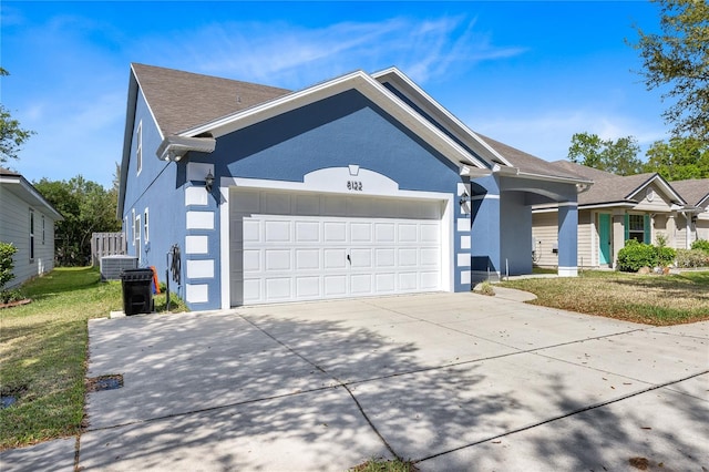 view of front of house featuring a garage and a front lawn