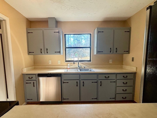 kitchen featuring gray cabinetry, sink, and dishwasher