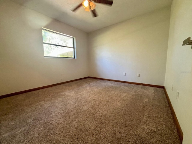 carpeted spare room with ceiling fan