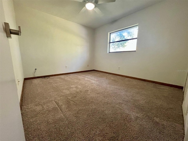 spare room with carpet floors and ceiling fan