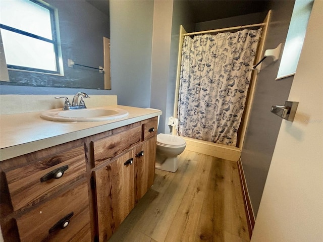 bathroom featuring a shower with curtain, vanity, toilet, and wood-type flooring