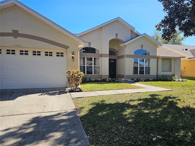 single story home with a garage and a front yard