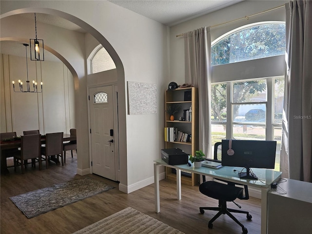 home office featuring wood-type flooring, a textured ceiling, and an inviting chandelier