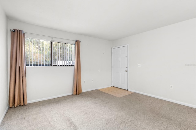 unfurnished room featuring light colored carpet