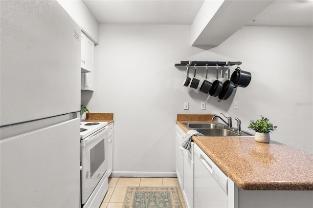 kitchen with white cabinetry, sink, light tile patterned floors, and white appliances