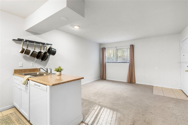 kitchen with white cabinetry, sink, white dishwasher, and light colored carpet