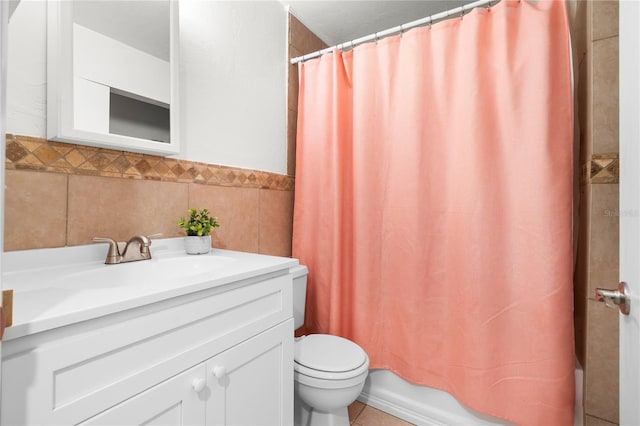 full bathroom with shower / bath combo, vanity, toilet, and tile walls