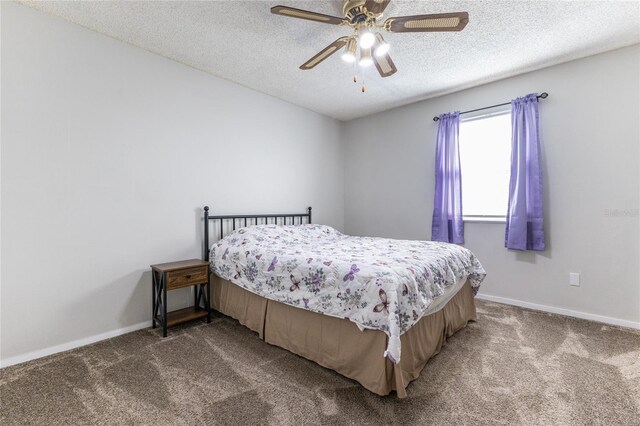 6519 W Newberry Rd Unit 805, Gainesville, FL 32605 - carpeted bedroom featuring a textured ceiling, a ceiling fan, and baseboards