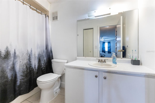 bathroom with vanity, toilet, and tile patterned floors