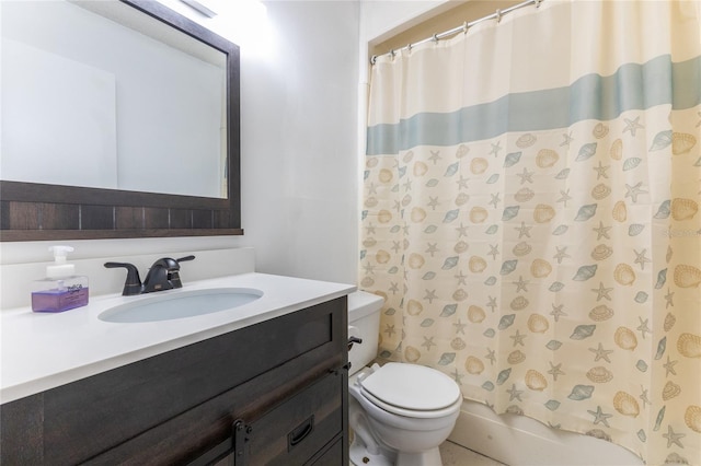 full bathroom with vanity, shower / tub combo with curtain, and toilet