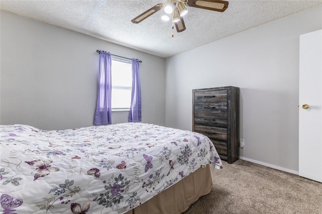 bedroom featuring light colored carpet, a textured ceiling, and ceiling fan