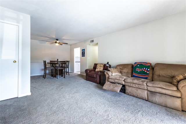 carpeted living room featuring ceiling fan