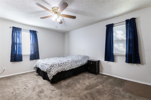 carpeted bedroom with a textured ceiling and ceiling fan