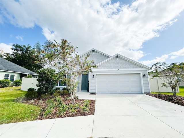 view of front of house with a front yard and a garage