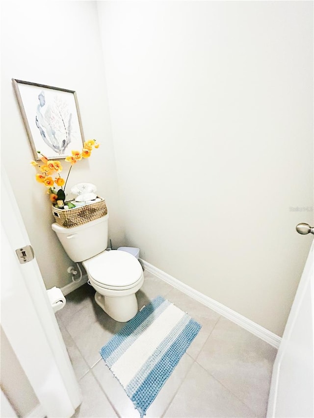 bathroom with tile patterned flooring and toilet