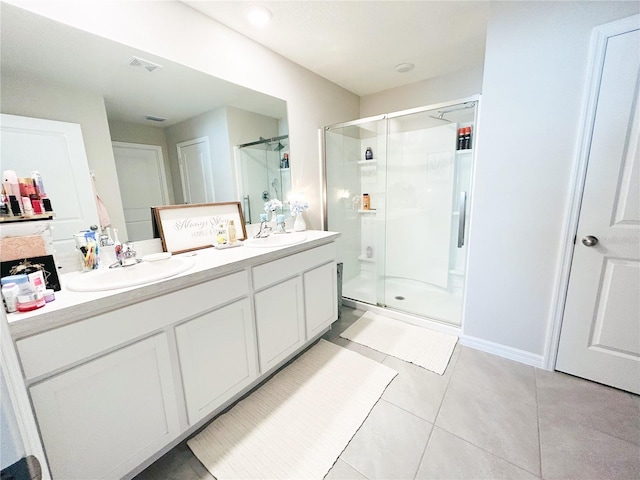 bathroom with tile patterned floors, a shower with shower door, and vanity