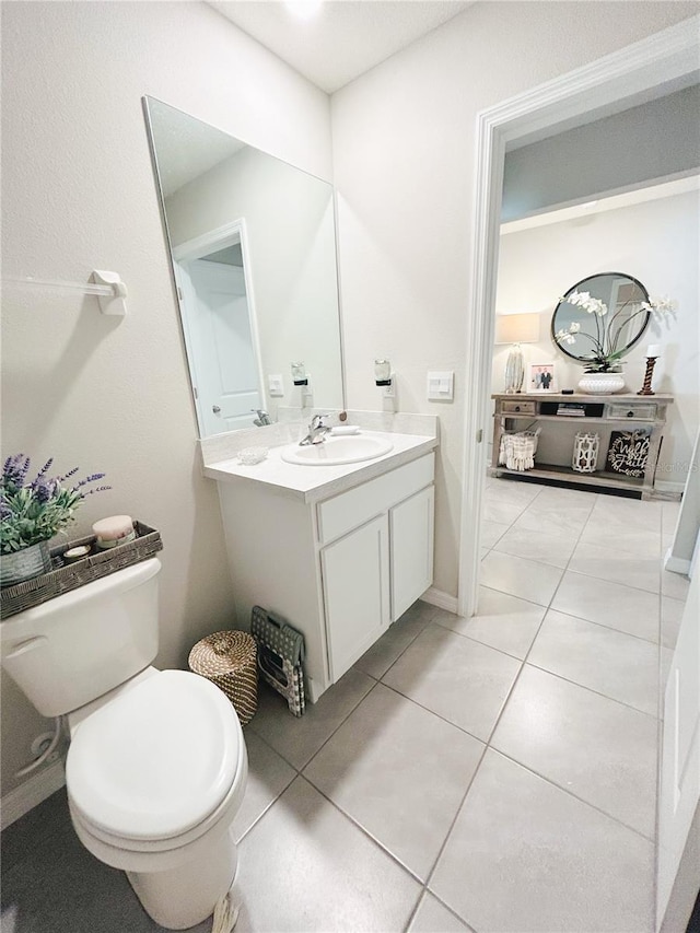 bathroom with vanity, tile patterned flooring, and toilet