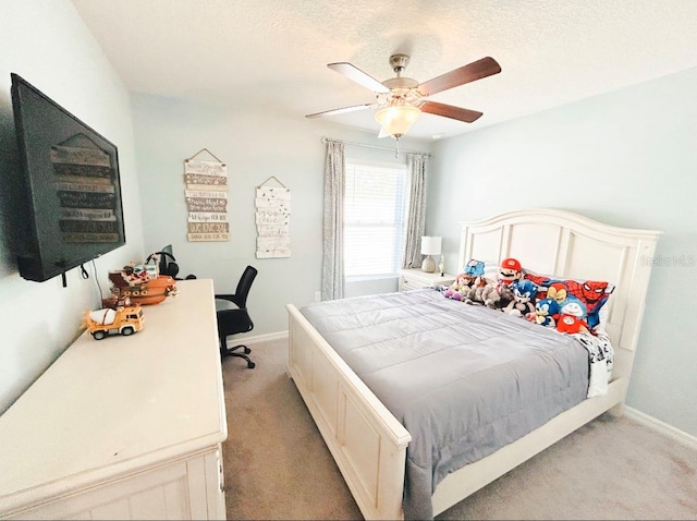 carpeted bedroom with ceiling fan and a textured ceiling