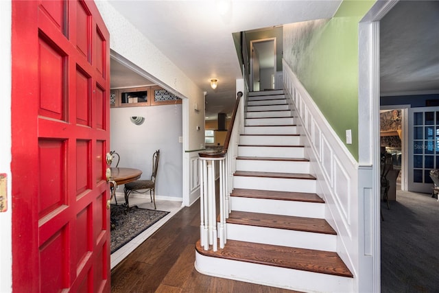 interior space featuring ornamental molding and dark hardwood / wood-style floors