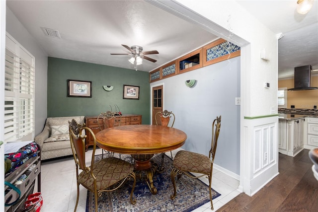 dining area with hardwood / wood-style floors and ceiling fan