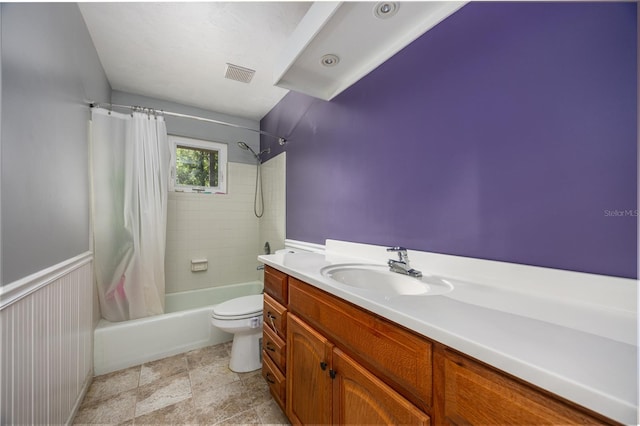 full bathroom featuring shower / bath combination with curtain, toilet, and vanity