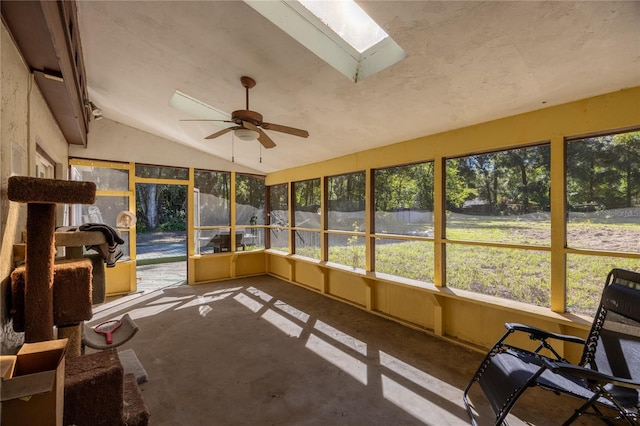 sunroom / solarium featuring ceiling fan and vaulted ceiling with skylight