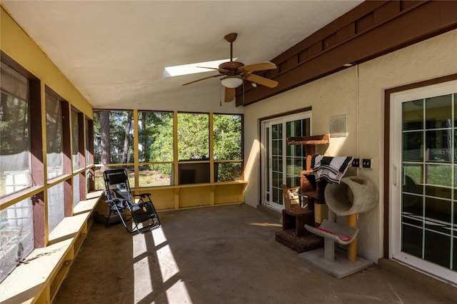 sunroom / solarium with vaulted ceiling with skylight and ceiling fan