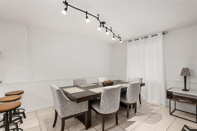 tiled dining space with rail lighting