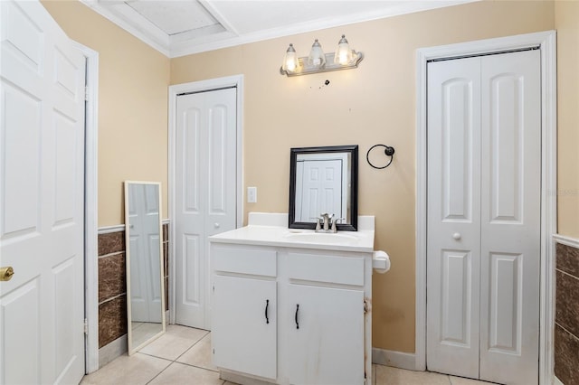 bathroom with crown molding, tile patterned floors, vanity, and tile walls