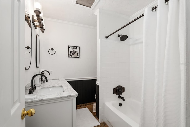 bathroom featuring ornamental molding, shower / bath combo with shower curtain, and vanity