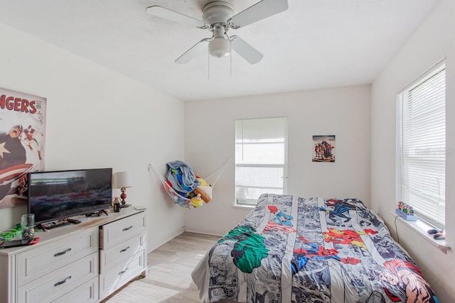 bedroom with ceiling fan and light hardwood / wood-style floors