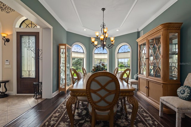 dining room with ornamental molding, a chandelier, and dark hardwood / wood-style floors