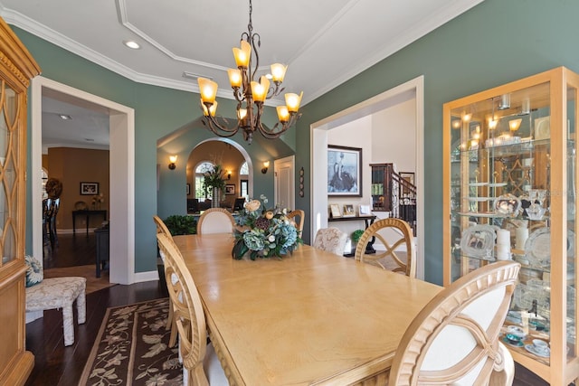 dining area featuring ornamental molding, dark hardwood / wood-style floors, and an inviting chandelier