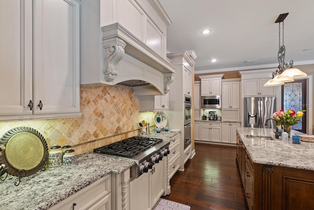 kitchen with dark wood-type flooring, appliances with stainless steel finishes, decorative light fixtures, and white cabinetry