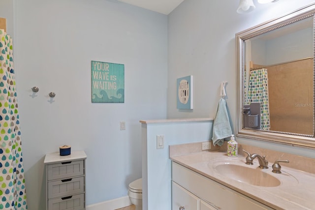 bathroom with toilet and vanity