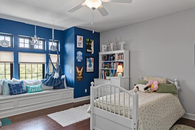 bedroom with dark hardwood / wood-style flooring and ceiling fan