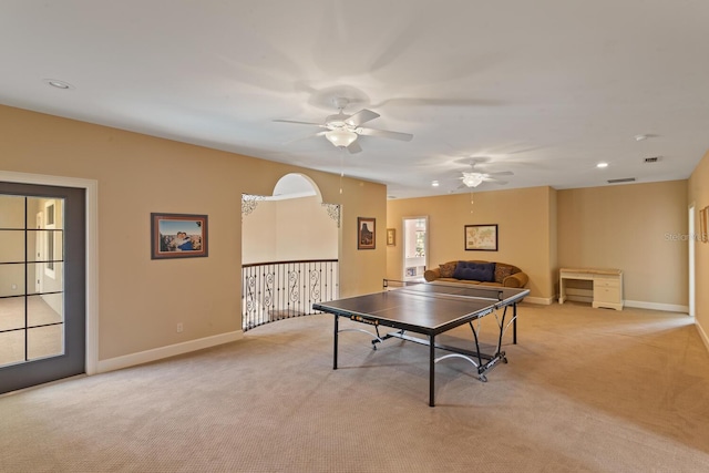 recreation room with light colored carpet and ceiling fan