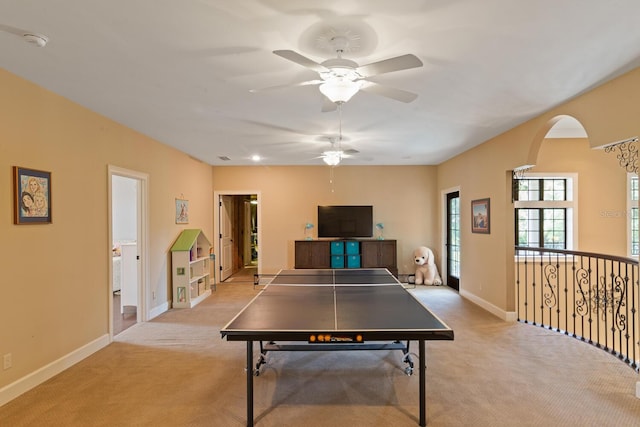 game room with light colored carpet and ceiling fan