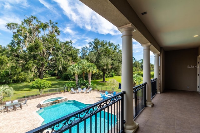 view of swimming pool with an in ground hot tub and a patio