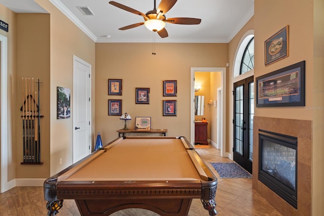 playroom with ornamental molding, a tiled fireplace, billiards, and ceiling fan