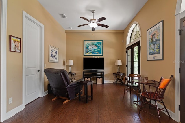 sitting room featuring dark wood-type flooring and ceiling fan